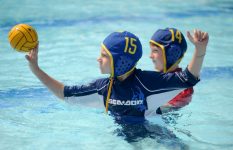 9-year-old Ann Arbor resident Daniel Zeimet, right, watches 8-year-old Ann Arbor resident Austin Gilghrist practice shooting goals at the Buhr Park Water Polo Camp in Ann Arbor on Aug. 20, 2010. Angela J. Cesere | AnnArbor.com